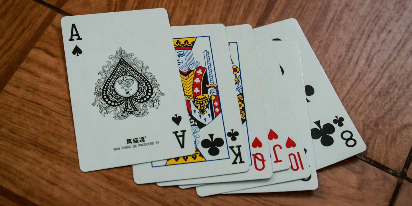 Seven Assorted Playing Cards on Brown Wooden Surface